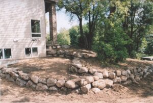 Boulder Wall Installation by Cedar Creek Landscaping